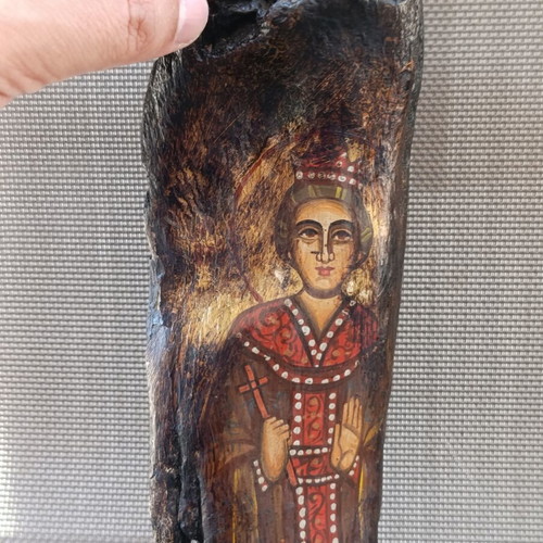 Old religious icon on wood trunk, handmade