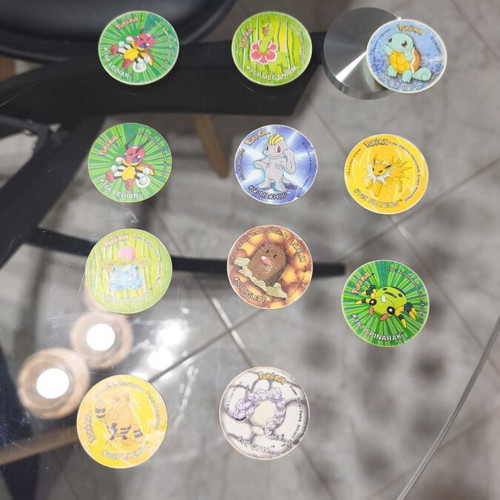 Pokemon Tazos used with visible wear