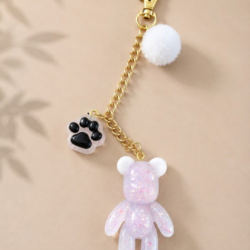 Handmade resin keychain with teddy bear and pom-pom