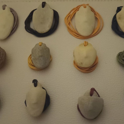 Collectible Cycladic idols, traditionally carved marble pendants