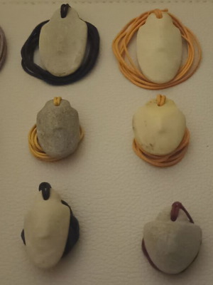 Collectible Cycladic idols, traditionally carved marble pendants