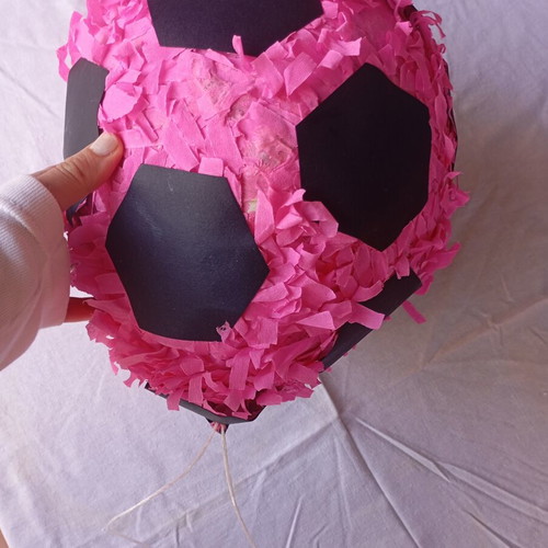 Piñata in the shape of a soccer ball like new, pink and black