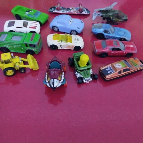 Set of various toy cars used, including helicopters and bulldozer