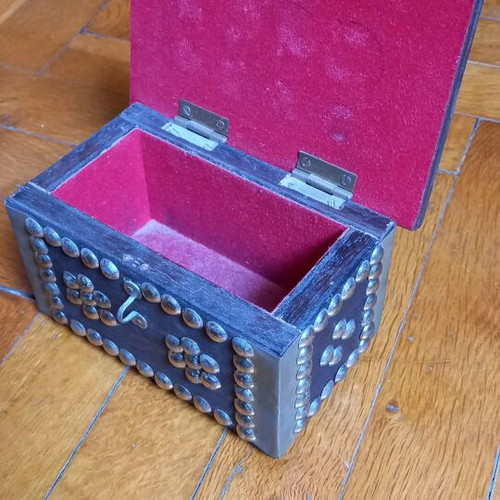 Decorative small wooden chest used with metal details