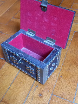 Decorative small wooden chest used with metal details