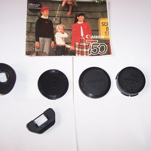 Canon T50 SLR analog camera used with two zoom lenses and flash