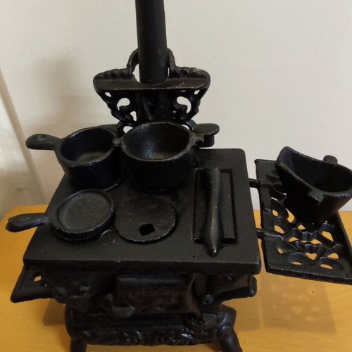 Miniature wooden stove with cast iron accessories like new