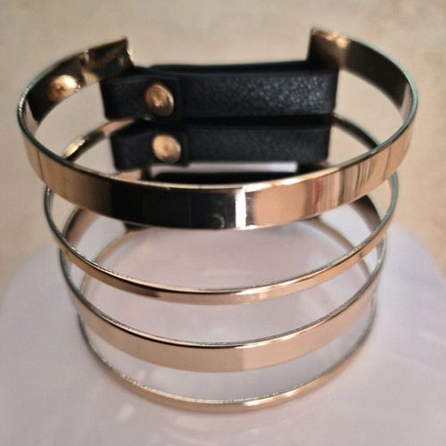 Metal cuff bracelet in rose gold color with black details like new