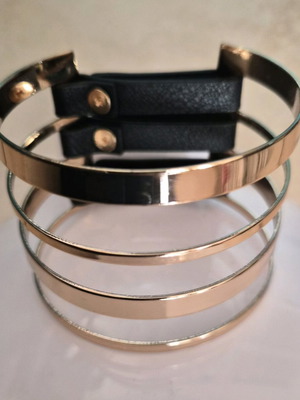 Metal cuff bracelet in rose gold color with black details like new