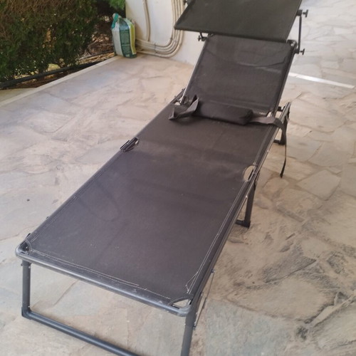 Black sunbed with moveable umbrella and comfort pillow like new