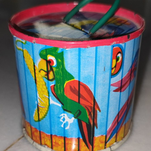 Vintage tin piggy bank used with parrots