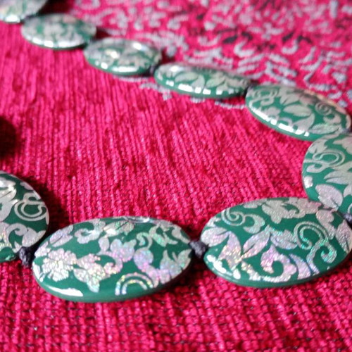 Acrylic green necklace used with holographic silver floral details