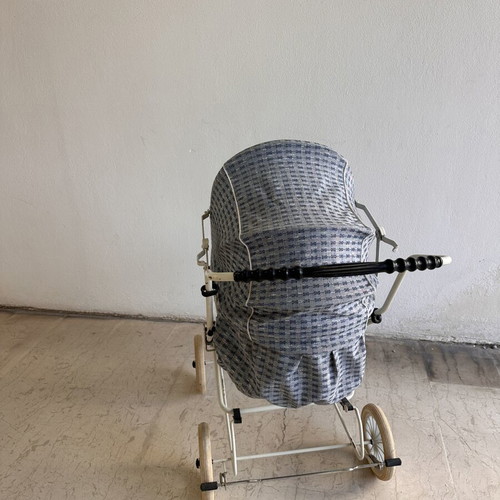Vintage baby stroller with classic check fabric and metal frame