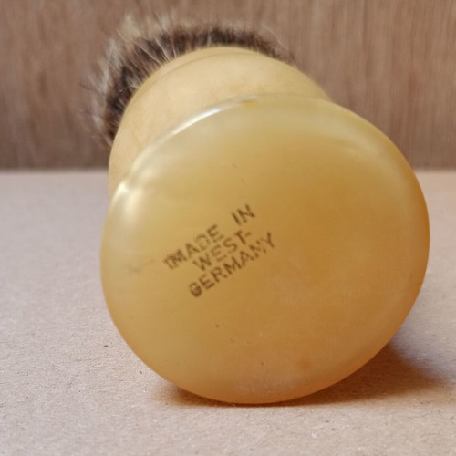 Two shaving brushes, one says it is made in West Germany.