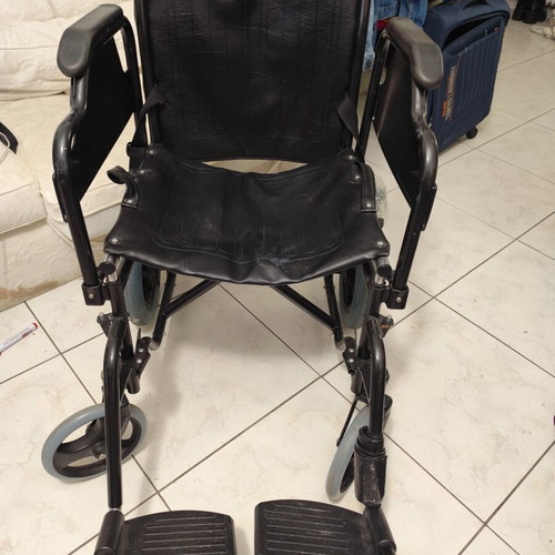 Manual wheelchair used with rear wheel brakes and belt