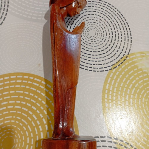 Handmade wooden Madonna statue in praying pose with halo