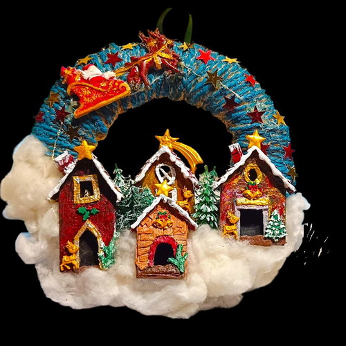Handmade wreath Santa Claus with sleigh in Christmas village lit with LED
