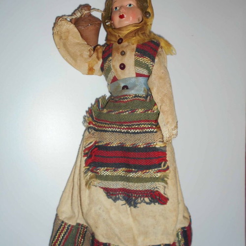 Folk handmade doll used with traditional costume and water jug