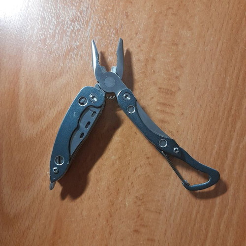 Survival multitool like new with knife, saw, screwdriver and pliers