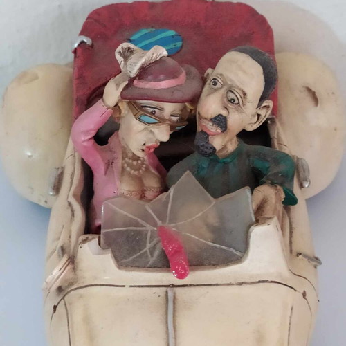 Ceramic funny money box, 25 cm length, funny couple in car, like new
