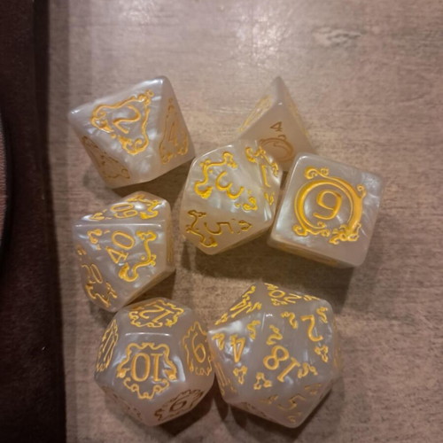 Brown leather dragon dice bag with white D&D dice