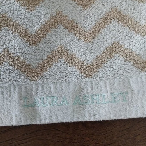 Laura Ashley face towel like new with geometric pattern light blue beige