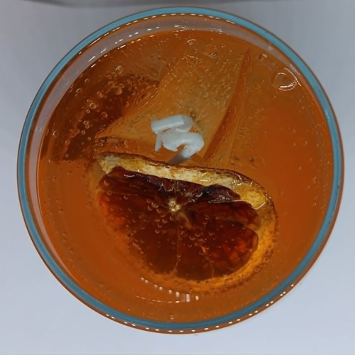 Handmade candle in Aperol Spritz glass with Aperol Spritz scent