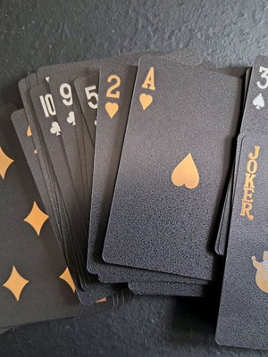 Black playing cards with gold details and case new, luxury design