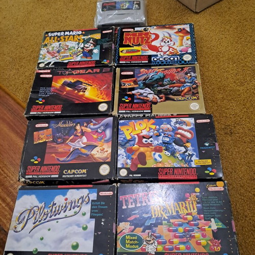 Super Nintendo Entertainment System console with 9 games