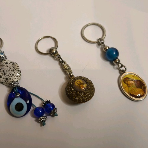 Set of 3 keychains like new with Meteora, evil eye and religious images