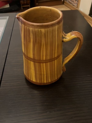 Handmade ceramic pitcher used in rustic barrel style