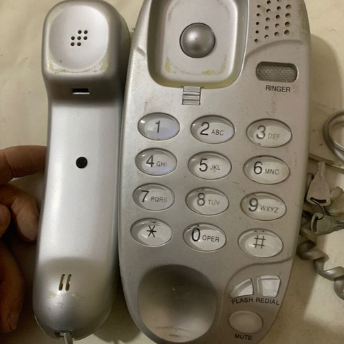 Simple old wired landline phone used, gray