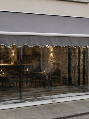 Electric awning with grey fabric and nylon side rolls