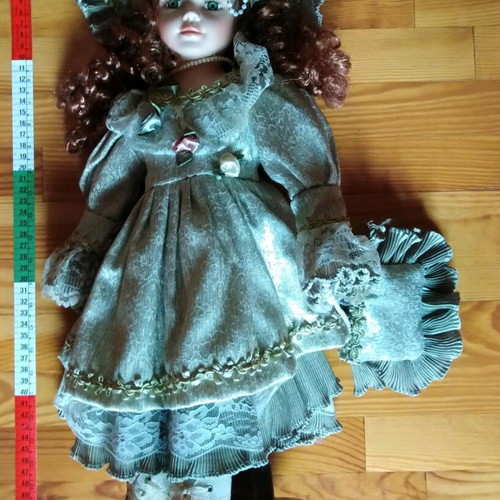 Porcelain doll with green eyes like new