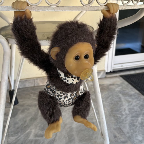 Vintage plush monkey toy with sound and hanging feature