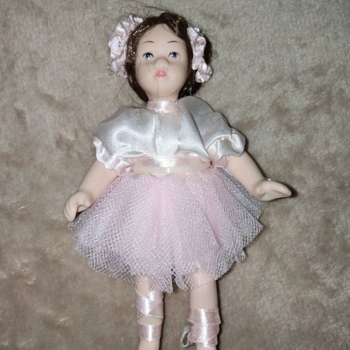 Porcelain doll like new, height 14.5 cm
