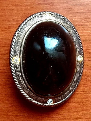 Vintage brooch used with black stone and silver frame