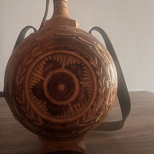 Wooden flask used with carved decoration and leather strap