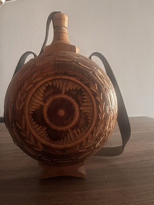 Wooden flask used with carved decoration and leather strap