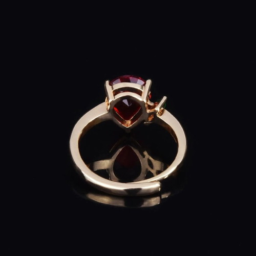 Adjustable ring with red teardrop stone and green detail, gold plated