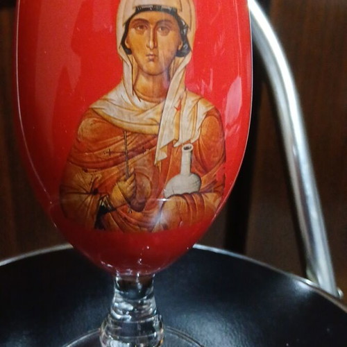 Red glass candlestick with double saints depiction, 17cm