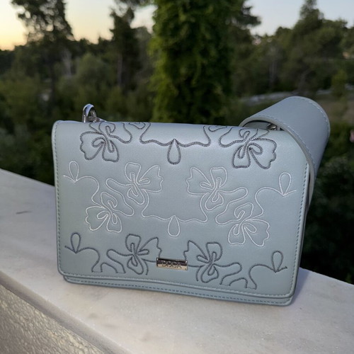 Doca crossbody bag like new, blue with embossed flower designs