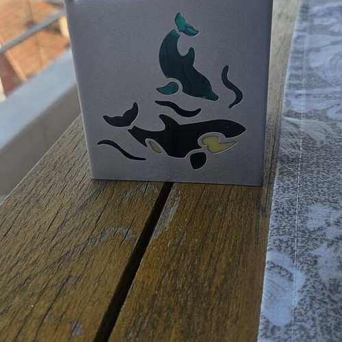 Metal tealight holder with stained glass dolphins