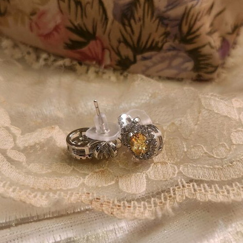 Steel earrings new with yellow stone and small diamonds