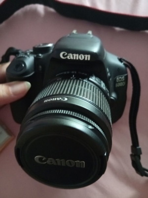 Canon EOS600D camera with 18-55mm lens, strap, charger, and two batteries