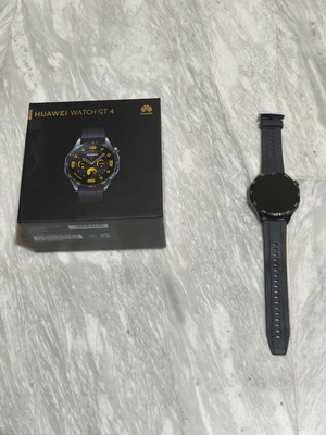 Huawei GT4 smartwatch with charger and 3 extra straps