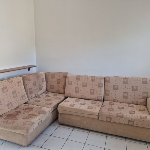 Corner sofa used, beige fabric, sturdy construction