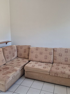 Corner sofa used, beige fabric, sturdy construction