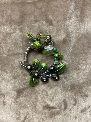 Brooch used, silver wreath with green details