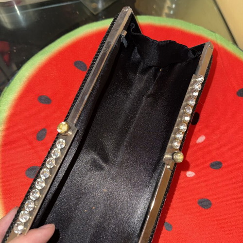 Black evening clutch bag with metallic details